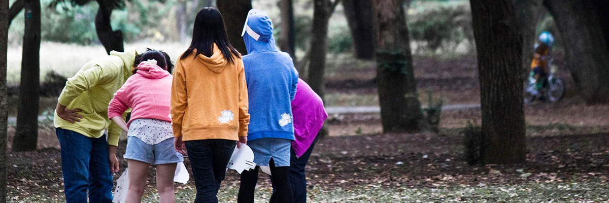 Group of kids from the back in a forest